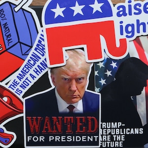 May include: A collage of political stickers featuring a red, white, and blue elephant, a red, white, and blue megaphone, a red, white, and blue box with the text "Liberal Tears" and "100% Natural", a red, white, and blue American flag with a silhouette of a person, and a photo of Donald Trump with the text "WANTED FOR PRESIDENT" and "TRUMP-REPUBLICANS ARE THE FUTURE".
