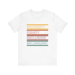 May include: White t-shirt with a retro-style graphic that reads "Diversity, Equity, Inclusion, Belonging". The words are in different colors and have a striped design.