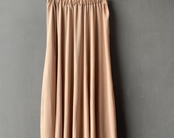 De onderrok is gemaakt van viscose in de kleur beige. Rok voor vintage looks. Rokje onder de jurk. Wijde rok. Lange rok.