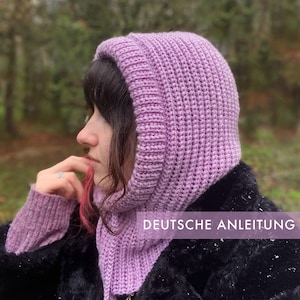 May include: A close-up of a person wearing a lavender knitted hooded scarf and matching hat. The text "DEUTSCHE ANLEITUNG" is visible in the image.