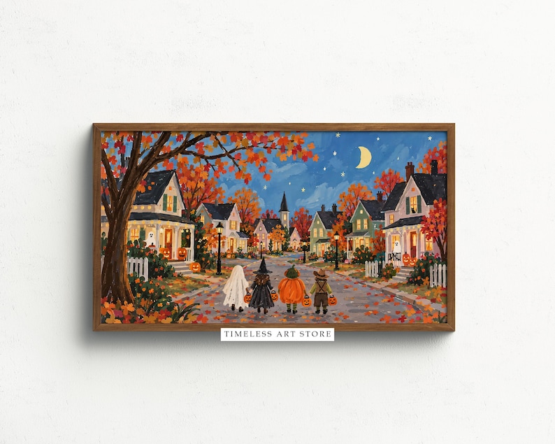 May include: A framed horizontal art print titled TIMELESS ART STORE depicting a neighborhood street at night during autumn. Four children in Halloween costumes walk down the road past houses with glowing windows, orange trees, and a crescent moon.
