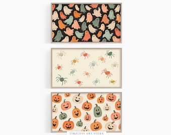 May include: Three rectangular framed wall art prints. The top print features a black background with repeating ghost illustrations in cream, orange, and sage green. The middle print has a cream background with orange and green spiders. The bottom print displays orange and green jack-o'-lanterns on a cream background. The text "TIMELESS ART STORE" is visible at the bottom.