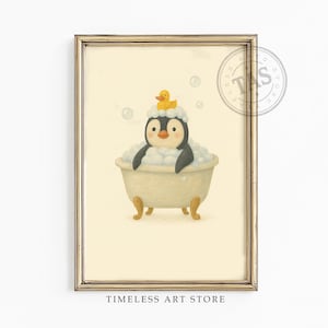 May include: A framed wall art print featuring a black and white penguin sitting in a cream-colored clawfoot bathtub filled with white bubbles. A small yellow rubber duck sits on top of the penguin's head. The text TAS is visible in a circular logo.