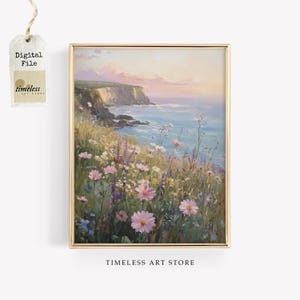May include: A framed digital art print of a coastal landscape. The artwork depicts a cliffside overlooking the sea, with wildflowers in the foreground. The colour palette includes blues, greens, pinks, and yellows. The text "Digital File" and "timeless ART STORE" are visible.