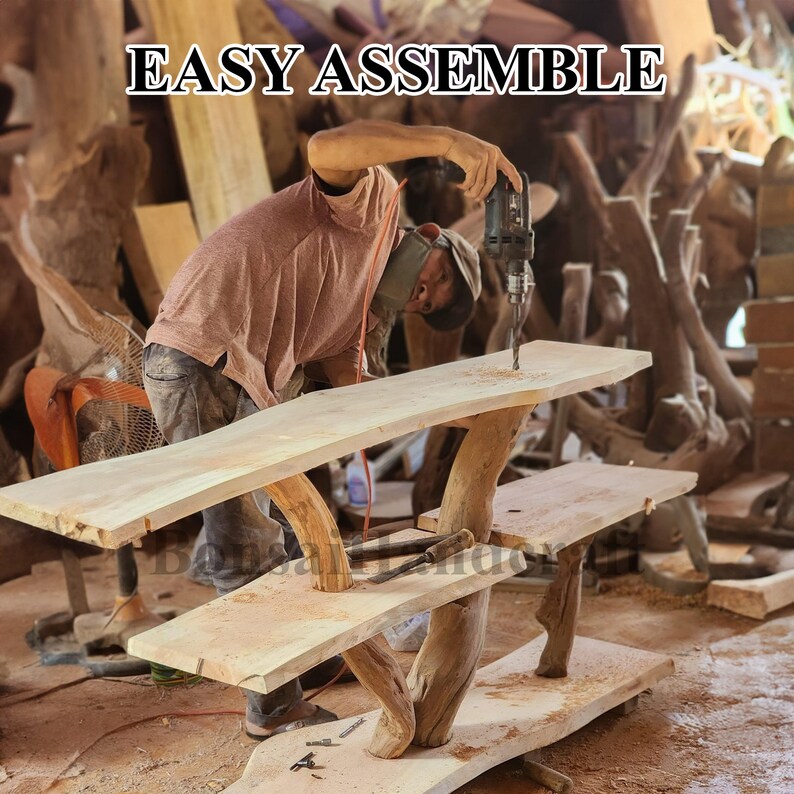 May include: A person assembles a wooden table with two shelves. The table is made of natural wood with a rustic finish. The table is being assembled with a drill. The text "EASY ASSEMBLE" is visible in the image.