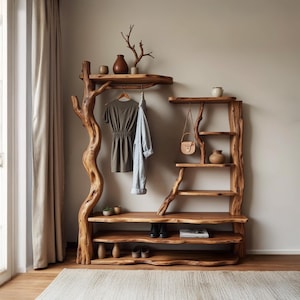 May include: A rustic wooden entryway organizer with a natural tree-branch design. It features shelves, a hanging rod for clothes, and decorative items. The warm brown tones of the wood create a welcoming and organic aesthetic. The organizer is designed for storage and display.