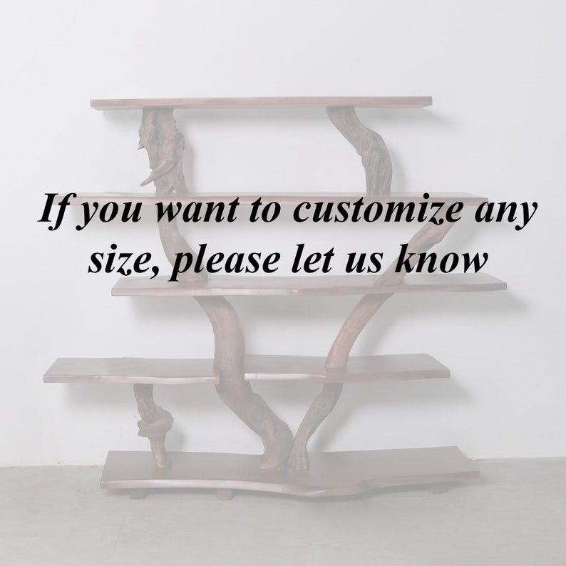 May include: A wooden shelf unit with three shelves, made from natural branches. The shelves are made from wood planks. The text "If you want to customize any size, please let us know" is printed on the white wall behind the shelf unit.