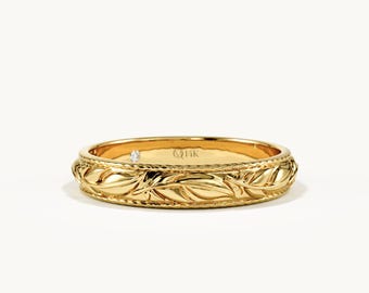 May include: A yellow gold band ring featuring a continuous embossed leaf pattern around the exterior. The edges of the ring are detailed with a fine beaded texture. The interior of the band is stamped with the text 14K, indicating the gold purity.