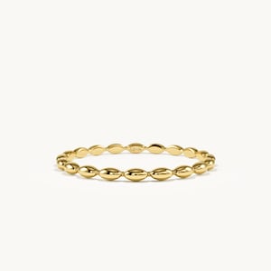 May include: A polished yellow gold ring featuring a continuous band of small, smooth, oval-shaped beads. The metal surface is reflective and shiny, and the interior of the band is clearly stamped with the text 14K to indicate its gold purity.