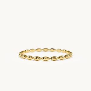 May include: A polished yellow gold ring featuring a continuous band of small, smooth, marquise-shaped beads linked together. The metal surface is reflective and shiny, and the interior of the band is clearly stamped with the text 14K.