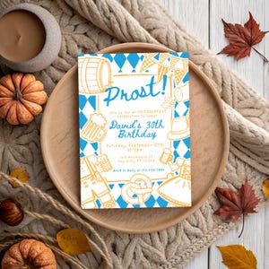 May include: An Oktoberfest-themed invitation with the word "Prost!" in a stylized font. The invitation features blue and white diamond patterns, beer steins, pretzels, and traditional German attire. The text reads "David's 30th Birthday" and includes event details.