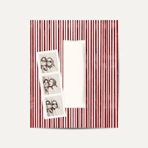 May include: A decorative photo frame with a red and white striped border. The frame holds a series of three black and white photo booth style pictures of two people. The background is a cream color.