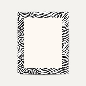 May include: A rectangular picture frame with a zebra print border in black and white. The frame has a cream-colored interior, creating a striking contrast. The zebra pattern adds a bold, animal-inspired design element.
