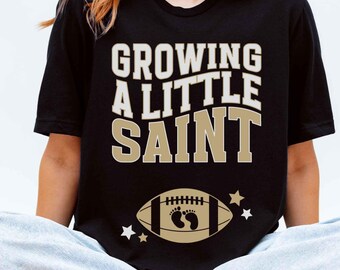 Growing A Little Saint Shirt New Orleans Football Pregnancy Announcement T-Shirt Maternity Gift for New Expecting NOLA Sports Mom Tee