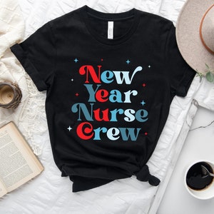 May include: Black t-shirt with the text "New Year Nurse Crew" in red, blue and white lettering. The text is in a retro font style.