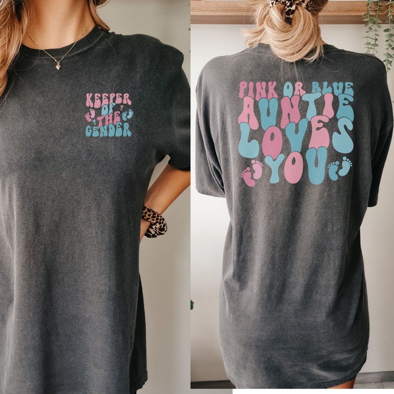 women wearing keeper of the gender shirt that says "pink or blue auntie loves you" on the back and "keeper of the gender" on the front pocket of theshirt.