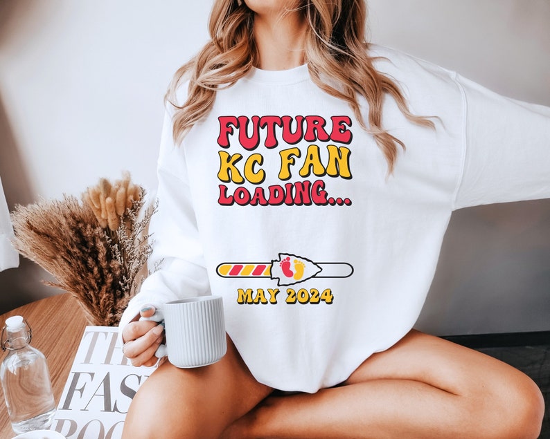 May include: White sweatshirt with the text "FUTURE KC FAN LOADING..." and a progress bar with the text "MAY 2024".