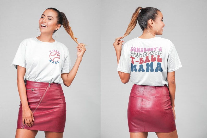 May include: White t-shirt with a red, white, and blue baseball graphic and the text "T-Ball Mama" on the front. The back of the shirt has the text "Somebody's Loud Mouth T-Ball Mama" in a retro font.