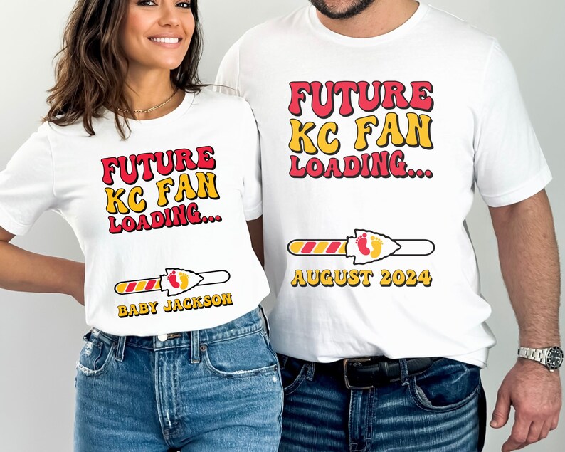 May include: White t-shirts with a red and yellow graphic that says "Future KC Fan Loading..." with a progress bar and a football-shaped arrow. The progress bar is filled with red and yellow stripes and has a red arrowhead with a yellow outline. The arrowhead has two yellow footprints. The text "August 2024" is below the progress bar on one shirt. The text "Baby Jackson" is below the progress bar on the other shirt.