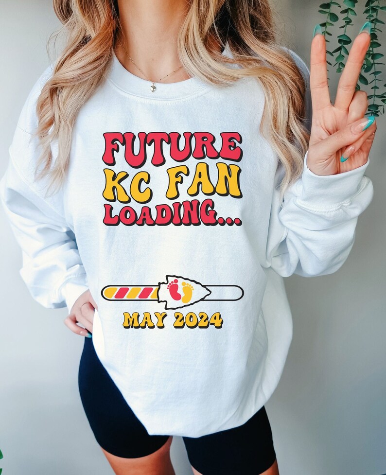 May include: White sweatshirt with a red and yellow graphic that says "FUTURE KC FAN LOADING..." with a progress bar that says "MAY 2024".