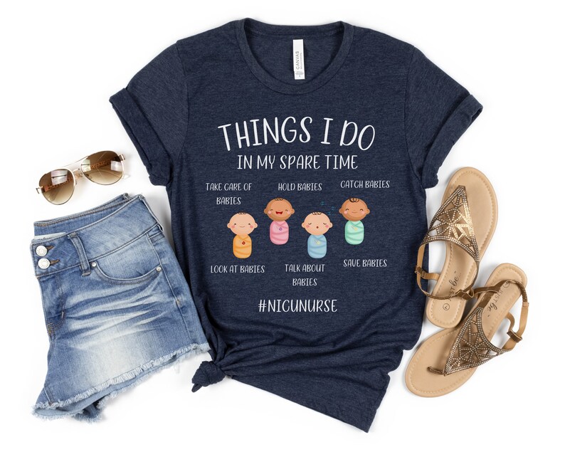 May include: A navy blue t-shirt with the text "THINGS I DO IN MY SPARE TIME" and a graphic of five baby figures with the text "TAKE CARE OF BABIES", "HOLD BABIES", "CATCH BABIES", "LOOK AT BABIES", "TALK ABOUT BABIES", "SAVE BABIES" and the hashtag "#NIGUNURSE".