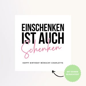 May include: White square card with black text that reads "EINSCHENKEN IST AUCH Schenken" in a bold font, with the word "Schenken" in pink script. Below, it says "HAPPY BIRTHDAY W&Uuml;NSCHT CHARLOTTE". A green circle with text is in the bottom right.