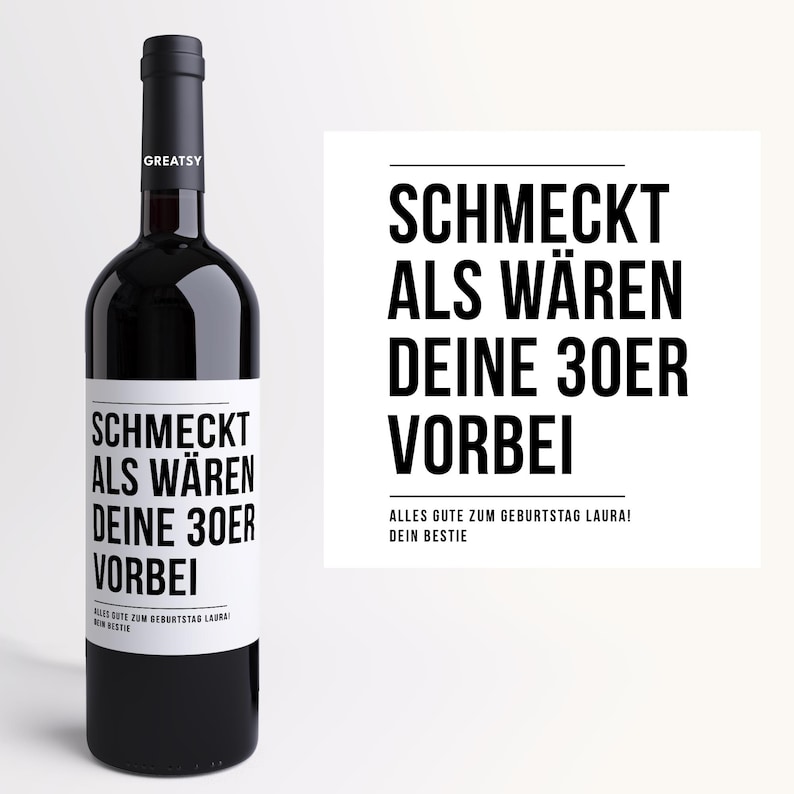 May include: A dark red wine bottle with a black cap and a white label. The label features the text "SCHMECKT ALS W&Auml;REN DEINE 30ER VORBEI" in black, with additional text below. A white card with the same text is to the right.
