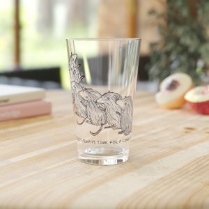 May include: A clear glass with a design of several mice on it. The text on the glass reads "There's always time for a cheese".