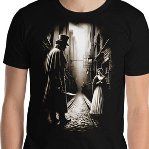 May include: Black t-shirt featuring a graphic print of a man in a top hat and coat standing in a dark alleyway with a woman in a white dress. The text "Jack the Ripper" is printed on the shirt.