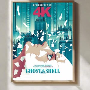 Könnte beinhalten: Ein gerahmtes Filmplakat für Ghost in the Shell mit dem stilisierten Profil eines Gesichts, umgeben von weißen schwebenden Scherben vor einer türkisfarbenen Stadtkulisse. Der Text lautet REMASTERED IN 4K, THE ORIGINAL ANIME MASTERPIECE RETURNS TO THEATERS SEPTEMBER 18 und GHOST IN THE SHELL.