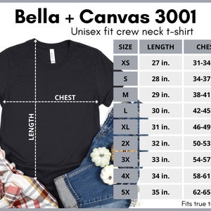 Puede incluir: Una camiseta de cuello redondo unisex negra Bella + Canvas 3001 con una tabla de tallas que muestra las medidas en pulgadas para el pecho y la longitud.