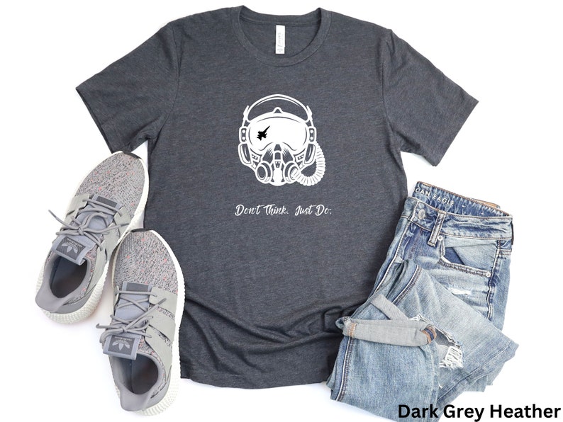 May include: Dark grey heather t-shirt with a white graphic of a pilot's helmet and the text "Don't Think, Just Do."