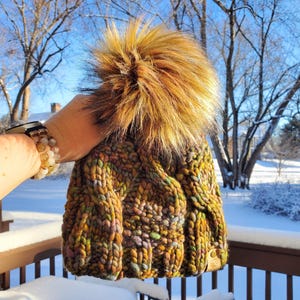 LUXURY LINE. Handknit Malabrigo Rasta Merino Wool Hat. Gold, Green, with hints of Blue. Warm cozy winter beanie. Giant faux fur pom pom.
