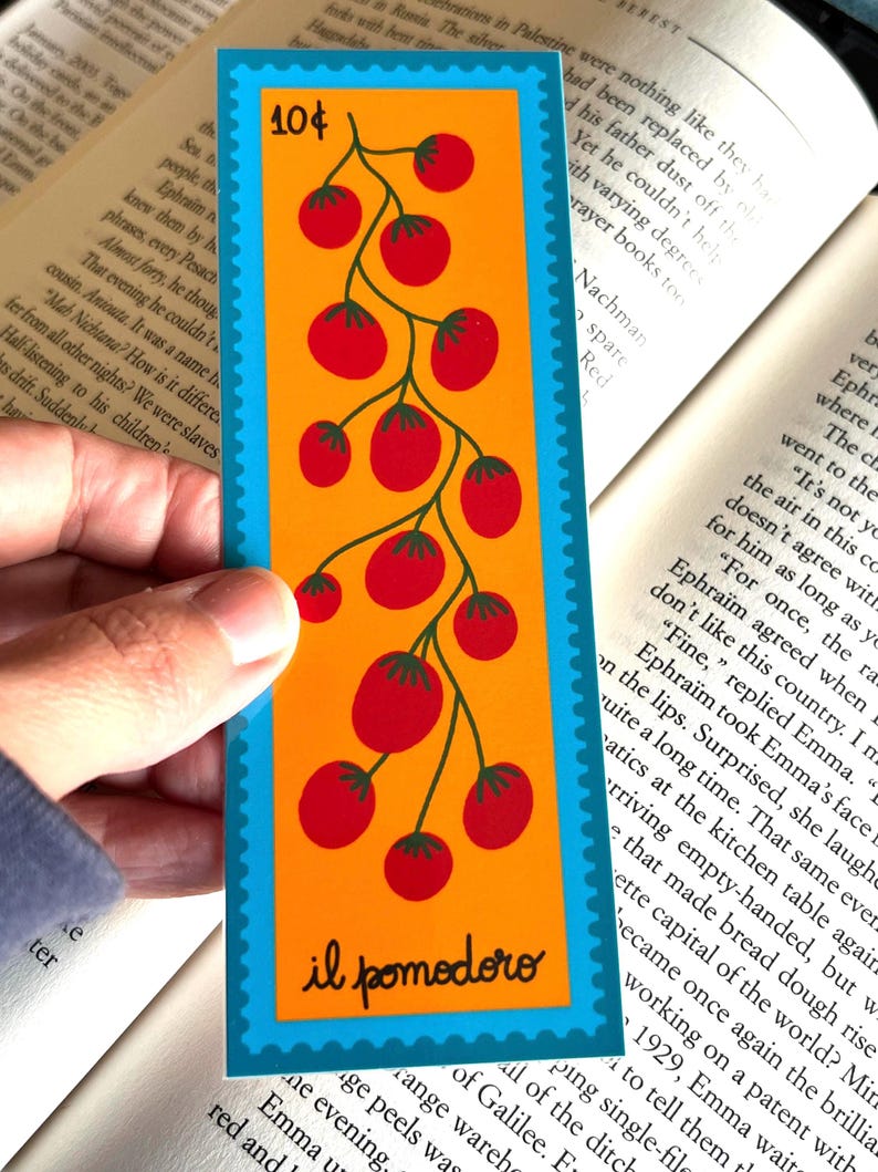 May include: A turquoise and orange bookmark with a red tomato vine illustration. The bookmark has the text "10&cent;" and "il pomodoro" printed on it.