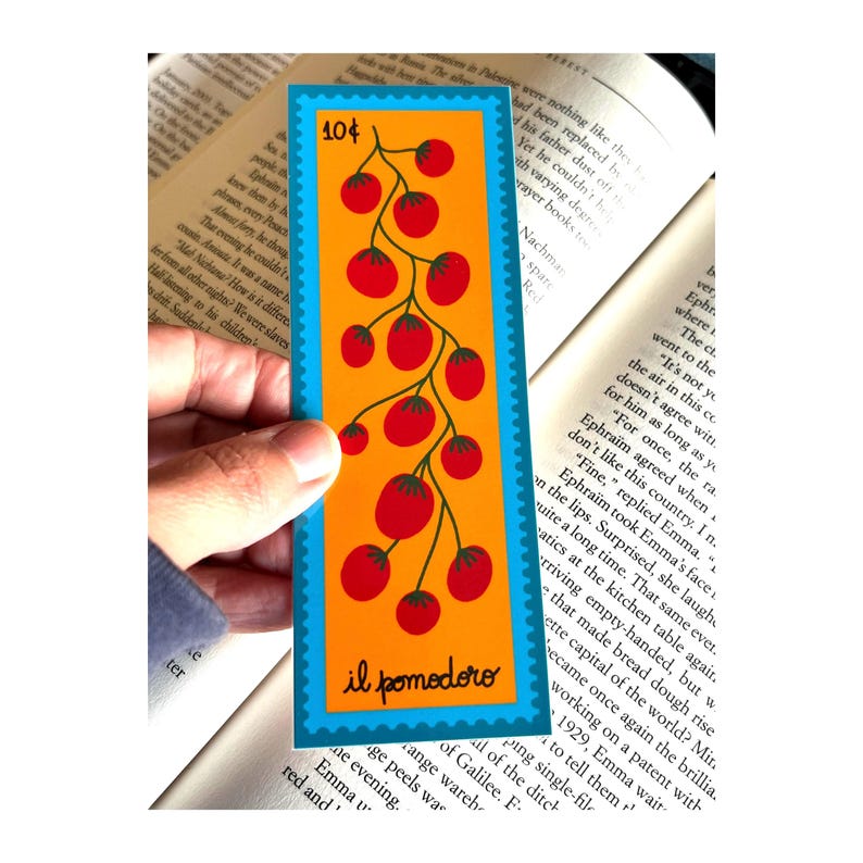 May include: A blue and orange bookmark with a red tomato vine illustration. The bookmark has the text "il pomodoro" and "10&cent;" printed on it.