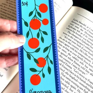 May include: A blue and green bookmark with a stamp that says "10&cent;" and a picture of orange trees with the word "L'oranges" at the bottom.