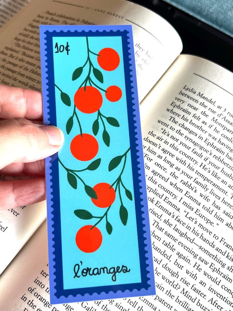 May include: A blue and green bookmark with a stamp that says "10&cent;" and a picture of orange trees with the word "L'oranges" at the bottom.