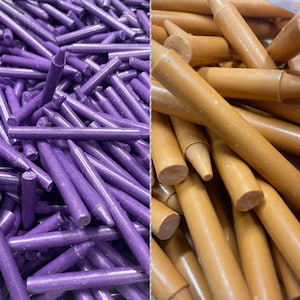 May include: Two bundles of crayons, one purple and one brown. The purple crayons are arranged in a random pattern, while the brown crayons are arranged in a more organized pattern.