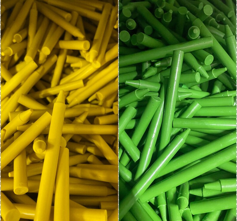 May include: A close-up image of two bundles of crayons. One bundle is yellow and the other is green. The crayons are arranged in a random pattern.