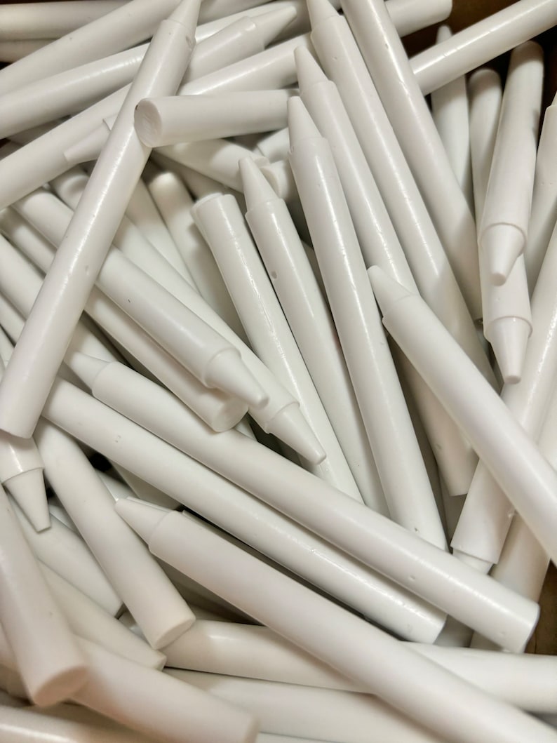 May include: A pile of white chalk sticks, arranged in a random pattern. The sticks are all the same size and shape, and they are all made of white chalk.