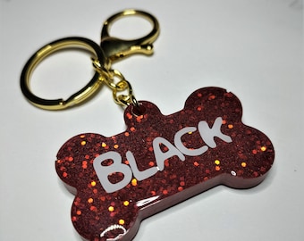 Resin identification tag for dog name and telephone number.