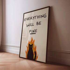 May include: A black framed poster with a black cat in flames and the text "EVERYTHING WILL BE FINE" in black handwriting.