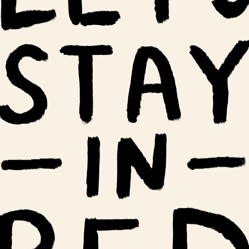 May include: Black and white text art print with the words "Let's Stay In Bed".