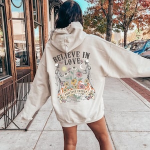 Trendy Hoodie with Back Print, BELIEVE IN LOVE, Retro Design w/ Flowers + Skeletons, Aesthetic Hooded Sweatshirt for Women, Positivity Gift