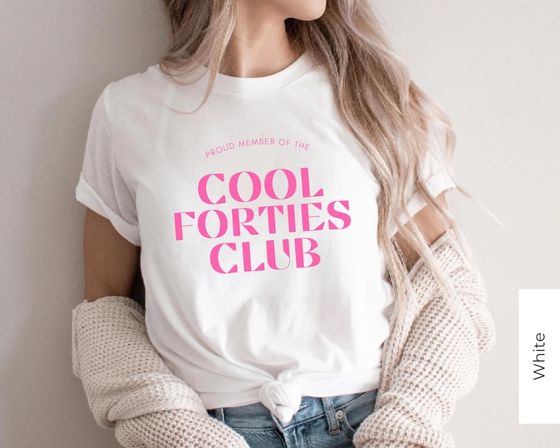 May include: White t-shirt with pink text that reads "Proud Member of the Cool Forties Club".