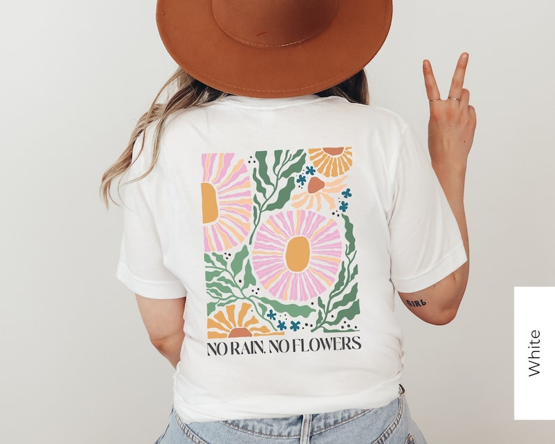 May include: White t-shirt with a floral graphic and the text "NO RAIN, NO FLOWERS".