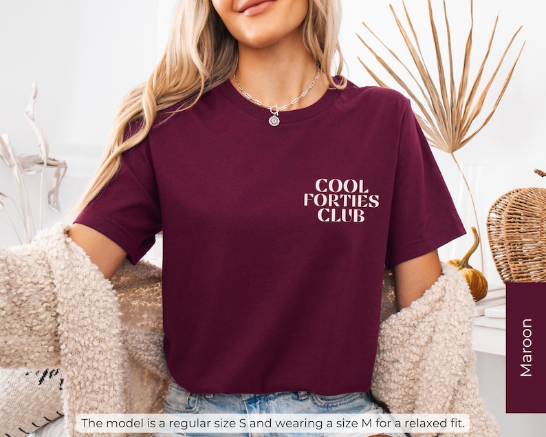 May include: A maroon t-shirt with white text that reads "Cool Forties Club".