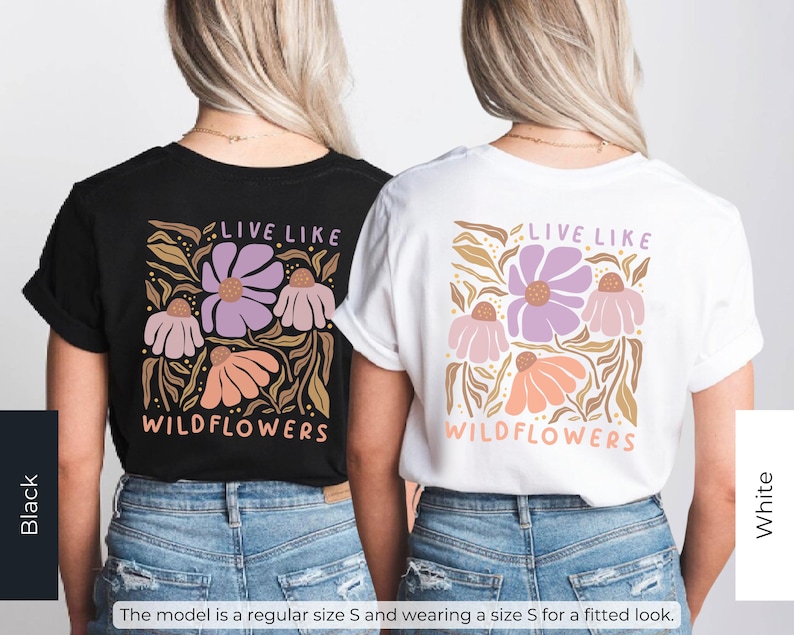 May include: Black and white t-shirts with a floral design. The shirts feature the text "LIVE LIKE WILDFLOWERS" in a stylized font. The floral design includes purple, pink, and orange flowers with brown leaves.