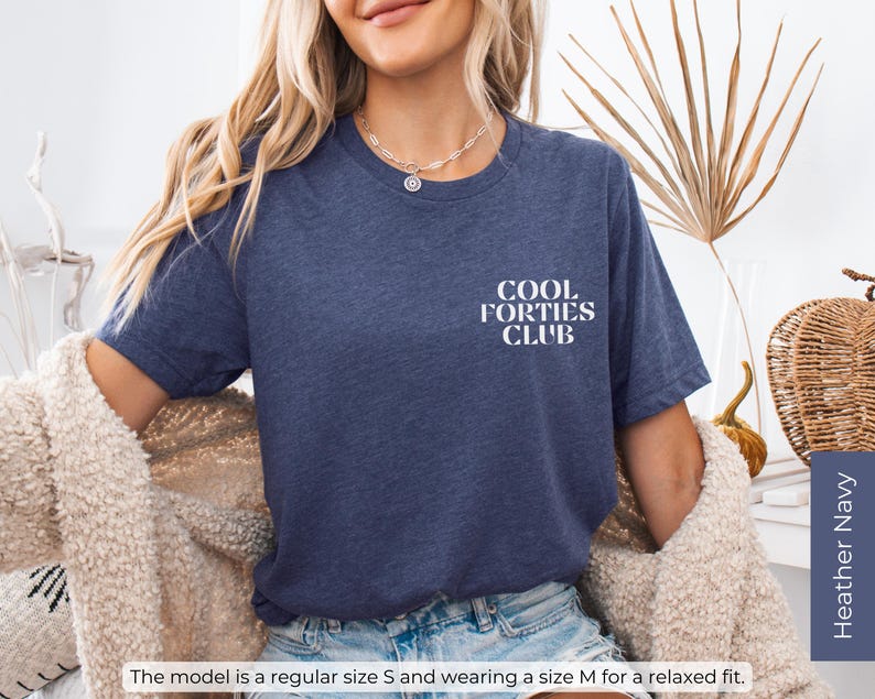 May include: A heather navy blue t-shirt with the text "Cool Forties Club" printed in white on the front.