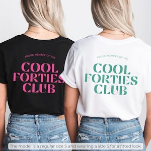 May include: Two black and white t-shirts with the text "Proud Member of the Cool Forties Club" in pink and teal lettering.